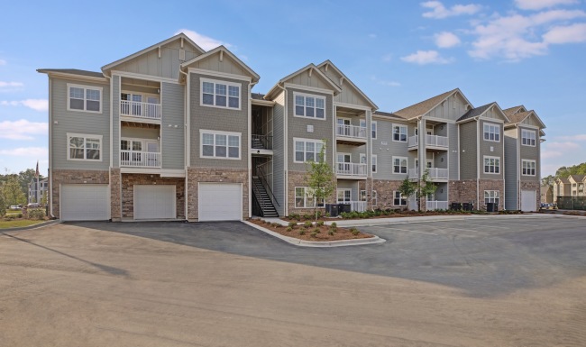 an apartment building with a parking lot