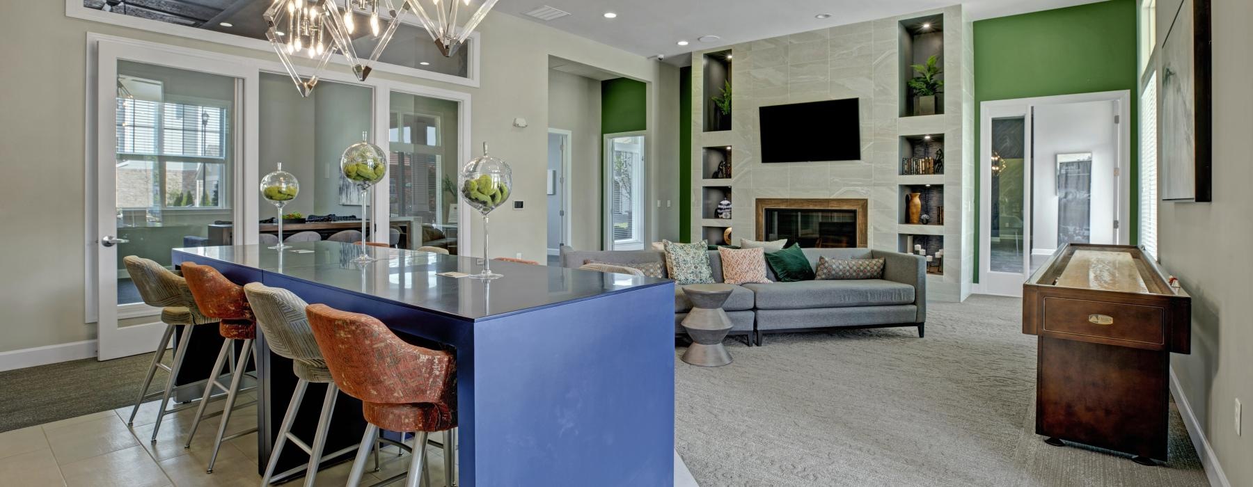 a large living room with a dining table and a large chandelier