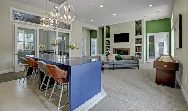 a large living room with a dining table and a large chandelier