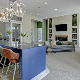 a large living room with a dining table and a large chandelier